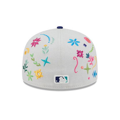 LA Dodgers MLB Heritage Light Beige New Era 59FIFTY Fitted Cap, rear view showing the multicoloured embroidered floral and geometric patterns across the light beige crown, with the MLB Batterman logo at the centre back above the straight visor.