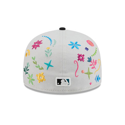 Chicago White Sox MLB Heritage Light Beige New Era 59FIFTY Fitted Cap, rear view showing the white embroidered MLB Batterman logo at the centre of the back panels, surrounded by multicoloured floral.