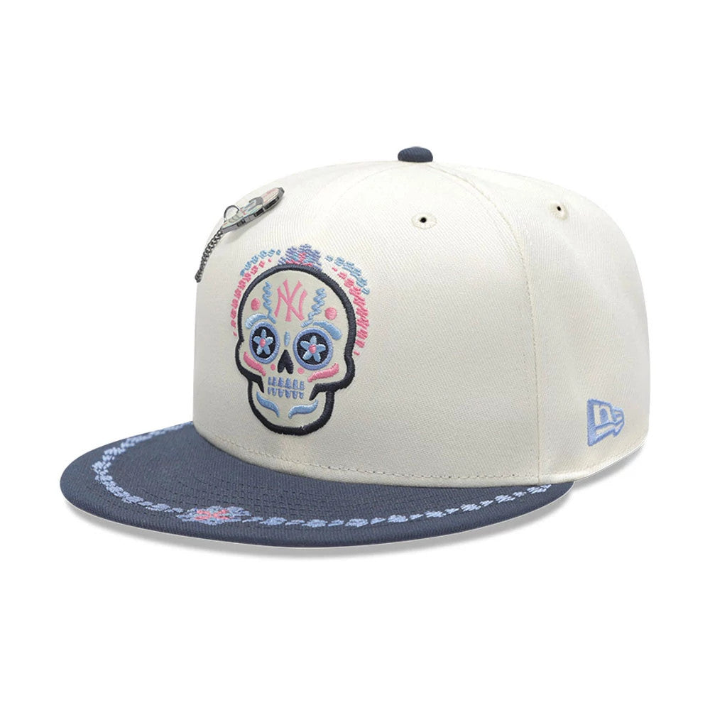 Pictured is this MLB Day Of The Dead New York Yankees 59FIFTY Fitted cap in light beige & dark blue. 3