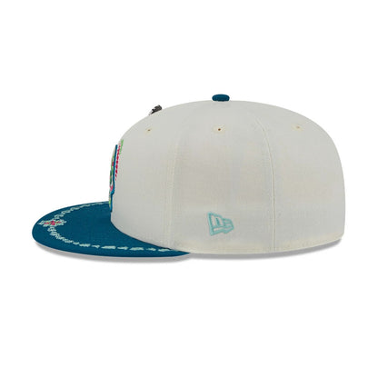 LA Dodgers MLB Day Of The Dead Light Beige & Blue New Era 59FIFTY Fitted Cap, side view showing the light blue embroidered New Era flag logo on the left, with a light beige crown and a decorated blue visor.