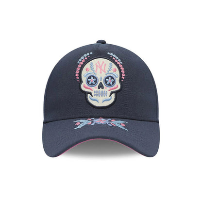 Yankees MLB Day Of The Dead Dark Blue New Era 9FORTY A-Frame Adjustable Cap, front view showing a multicoloured embroidered sugar skull design with a pink and light blue pattern, set above on the dark blue curved visor.