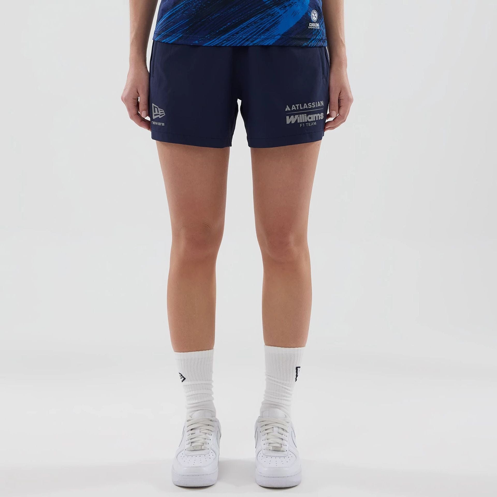 The model is wearing these Womens Atlassian Williams F1 Team Training Shorts in navy. 1