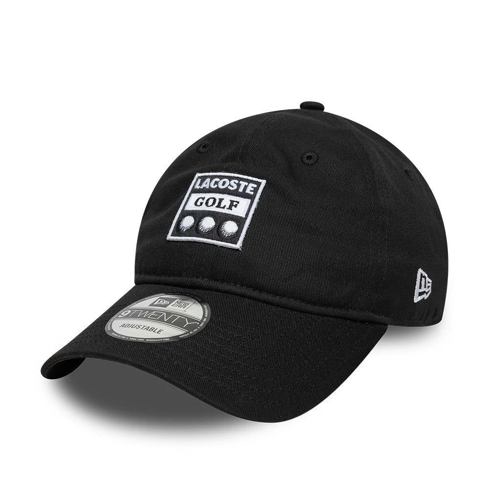 Lacoste X New Era Black 9TWENTY Adjustable Cap, three-quarter view showing the white embroidered Lacoste Golf logo on the front panel, black curved visor with a 9TWENTY size sticker, and the New Era flag logo on the left side.