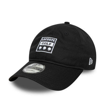 Lacoste X New Era Black 9TWENTY Adjustable Cap, three-quarter view showing the white embroidered Lacoste Golf logo on the front panel, black curved visor with a 9TWENTY size sticker, and the New Era flag logo on the left side.