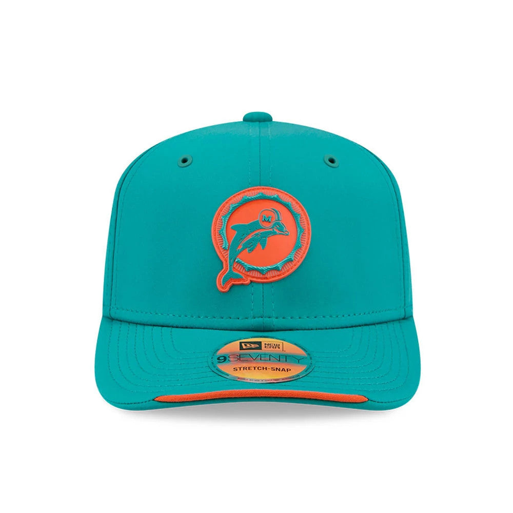 Dolphins NFL Sideline 2026 Turquoise New Era 9SEVENTY Stretch Snap Adjustable Cap, front view showing the raised orange and turquoise Dolphins logo on the structured crown, with a curved turquoise visor and 9SEVENTY size sticker.