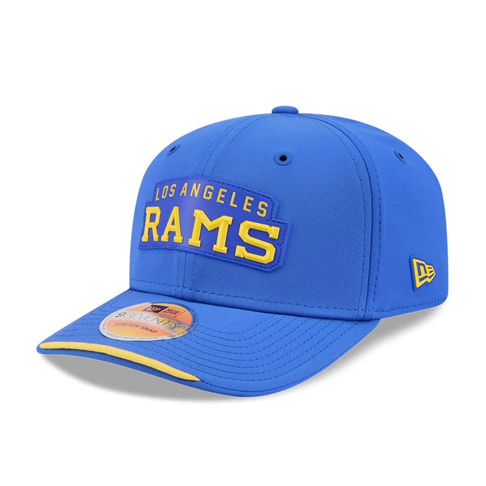 LA Rams NFL Sideline 2026 Blue New Era 9SEVENTY Stretch Snap Adjustable Cap, front view showing the yellow and white raised embroidered Los Angeles Rams lettering on the structured blue crown, with a contrasting yellow under-visor.