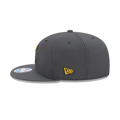 Steelers NFL Sideline 2026 Charcoal New Era 9FIFTY Snapback Adjustable Cap, side view showing the embroidered yellow New Era flag logo on the left side, a charcoal flat visor with a 9FIFTY size sticker, and a structured crown.