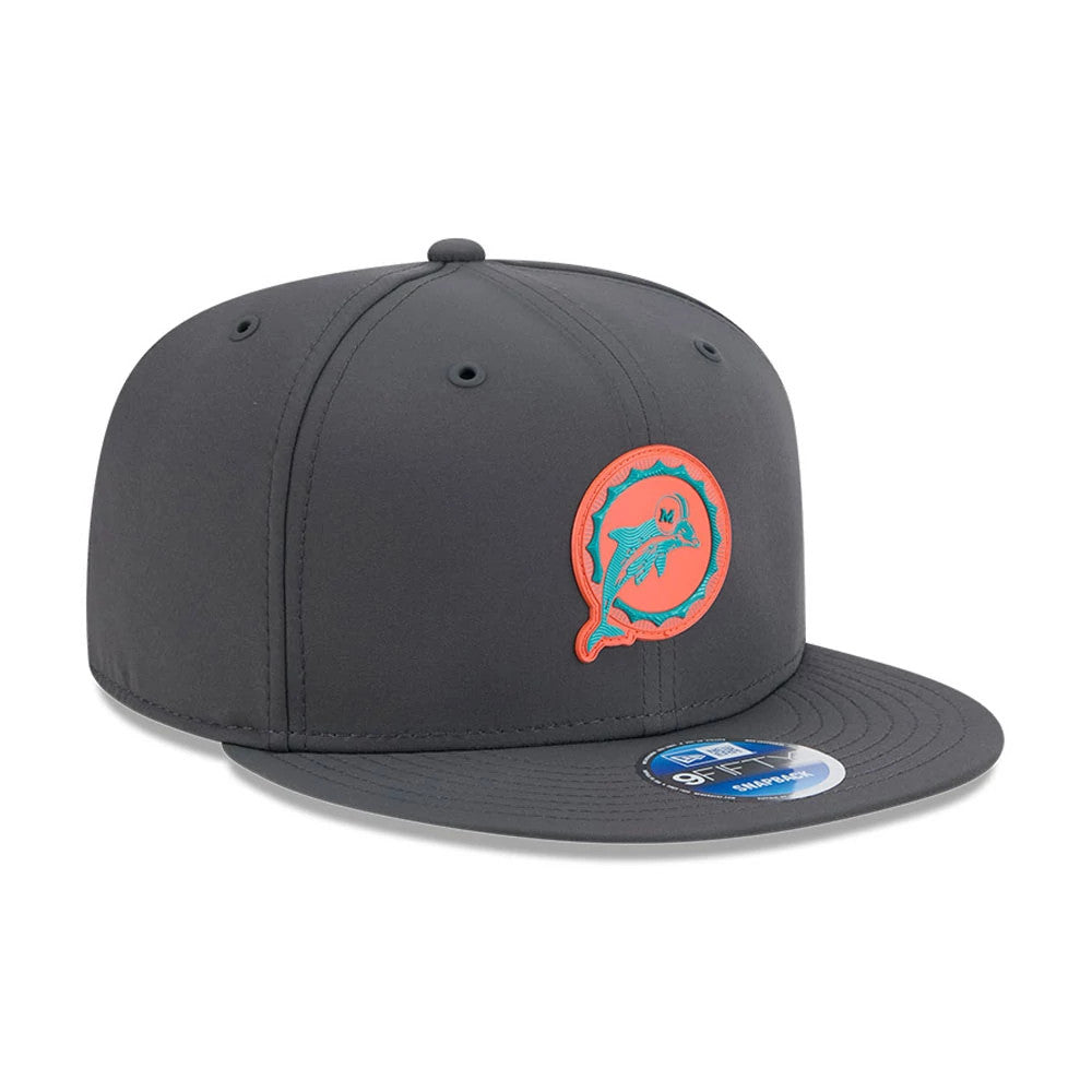 Miami Dolphins NFL Sideline 2026 Charcoal New Era 9FIFTY Snapback Adjustable Cap, three-quarter view showing the raised embroidered aqua and orange Dolphins logo on the front panel, with a grey visor and attached 9FIFTY size sticker.