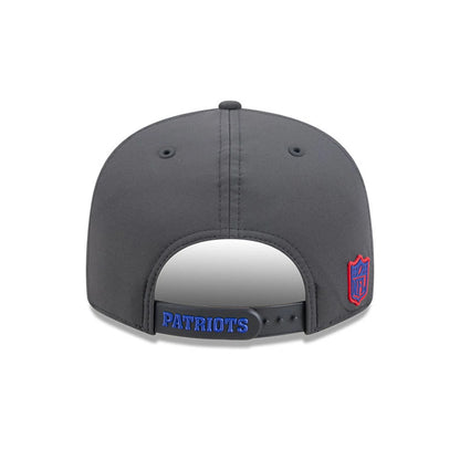 Patriots NFL Sideline 2026 Charcoal New Era 9FIFTY Snapback Adjustable Cap, rear view showing the blue embroidered Patriots text across the strap, with a red and blue NFL logo on the left side of the structured charcoal crown.
