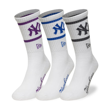 New Era New York Yankees MLB White 3 Pack Crew Socks, front view showing three pairs of white socks, each with a different coloured embroidered Yankees logo and stripe in purple, blue, and grey, the New Era logo below, and Yankees text on the foot.