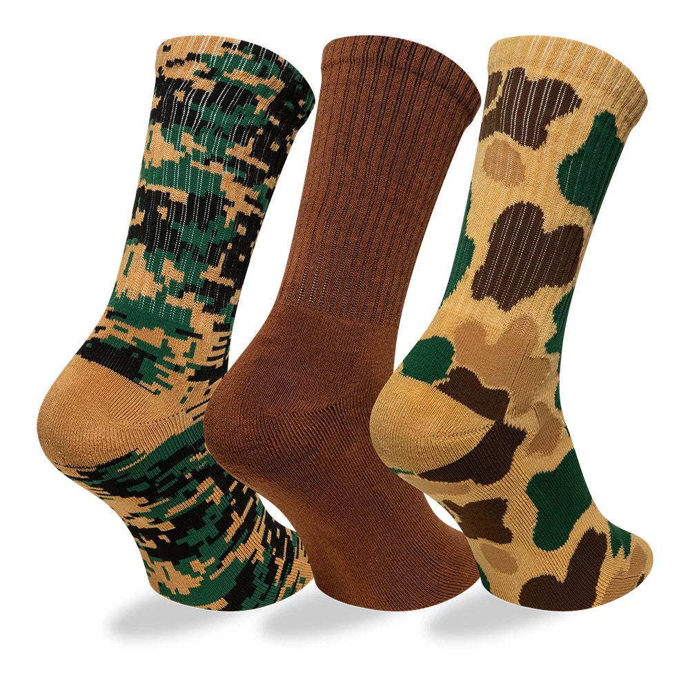 New Era Camo Brown 3 Pack Crew Socks, front view showing a set of three socks with different patterns: one in a green and black digital camo print, one in solid brown with thin vertical lines, and one in a classic brown and green camo print.