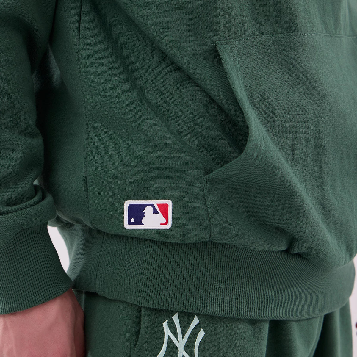 The model is wearing this MLB Midi League Essential New York Yankees Oversized Pullover Hoodie in dark green. 6