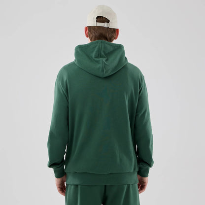 The model is wearing this MLB Midi League Essential New York Yankees Oversized Pullover Hoodie in dark green. 2