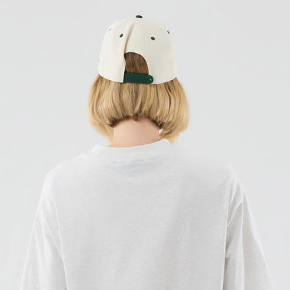 New Era New York Yankees MLB Arch Graphic Pastel Grey Oversized T-Shirt, back view on a model with short blonde hair wearing a light-coloured cap, highlighting the relaxed fit of the plain pastel grey shirt with a rounded neckline.