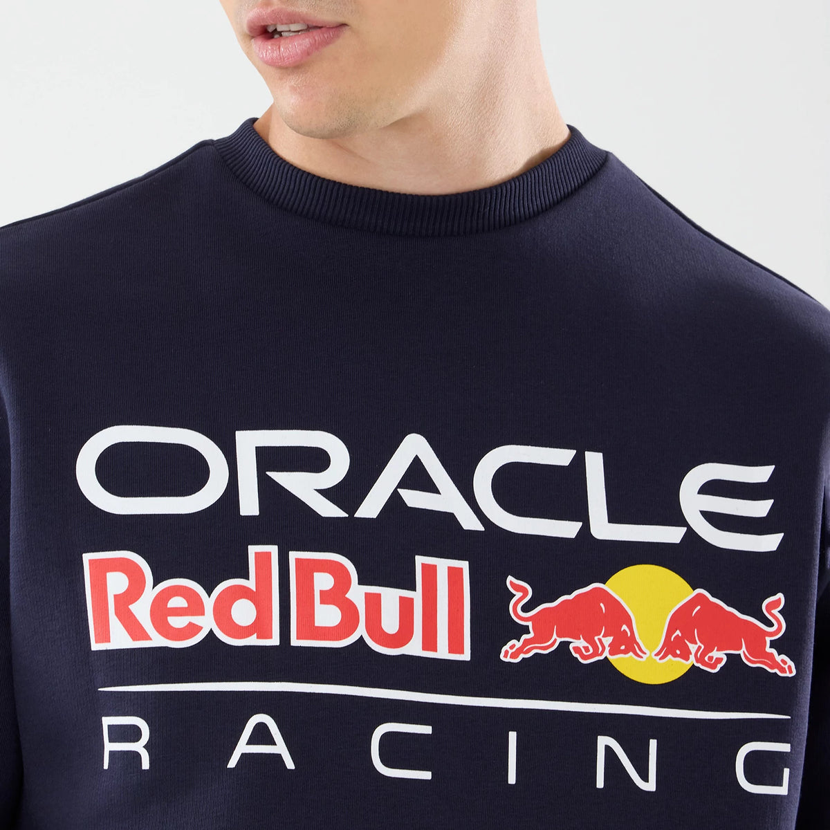 The model is wearing this Red Bull Racing Oversized Crew Neck Sweater in dark blue. 4