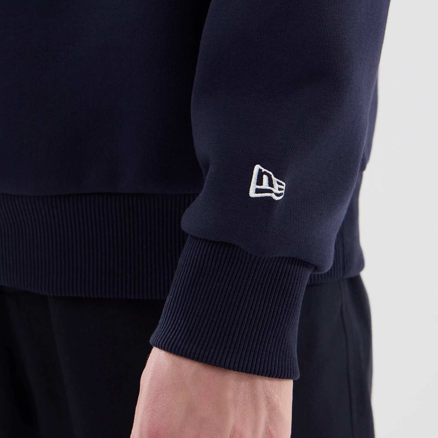 The model is wearing this Red Bull Racing Oversized Crew Neck Sweater in dark blue. 7