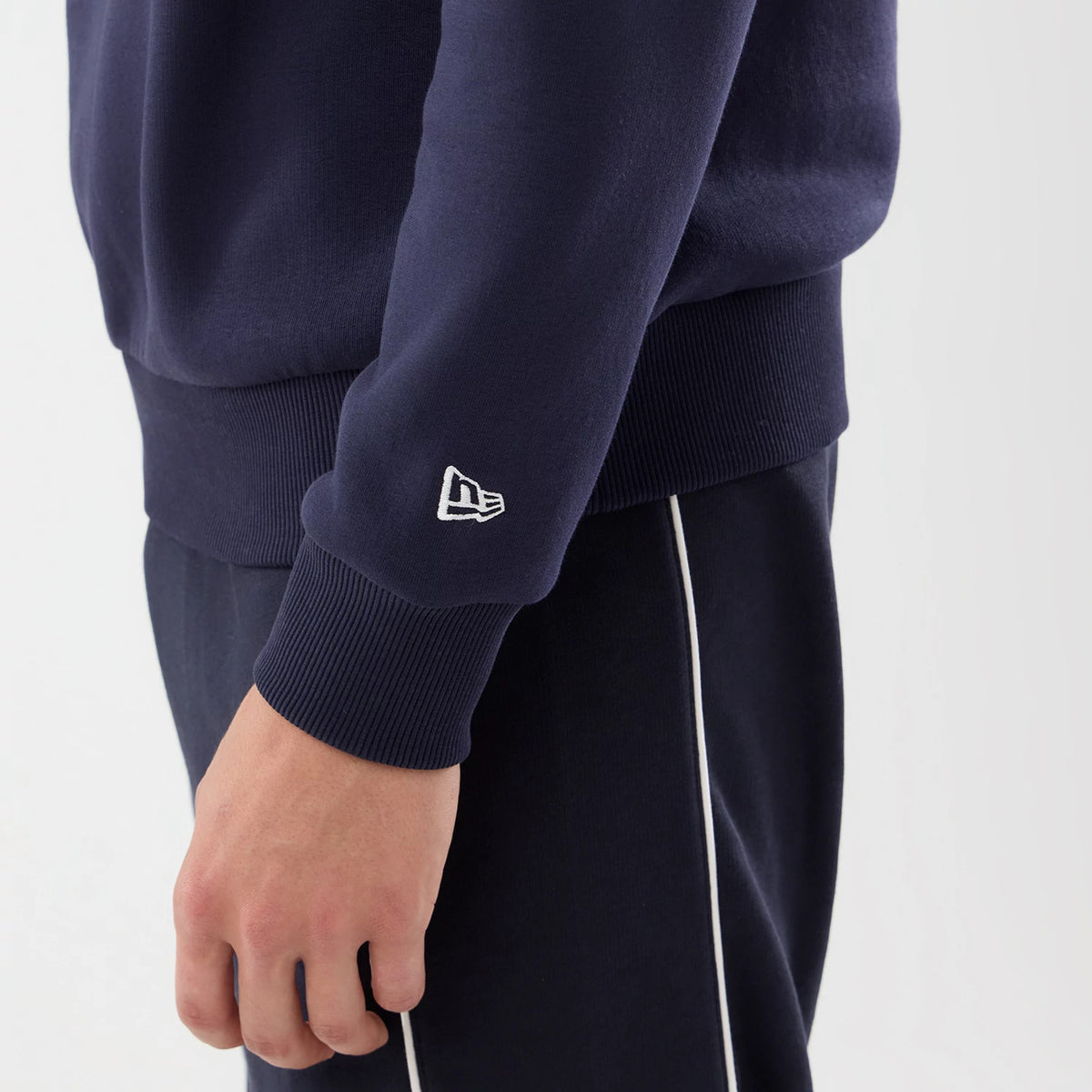 The model is wearing this Red Bull Racing Oversized Crew Neck Sweater in dark blue. 7