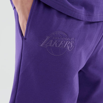 The model is wearing these NBA League Essential LA Lakers Oversized Shorts in purple. 4