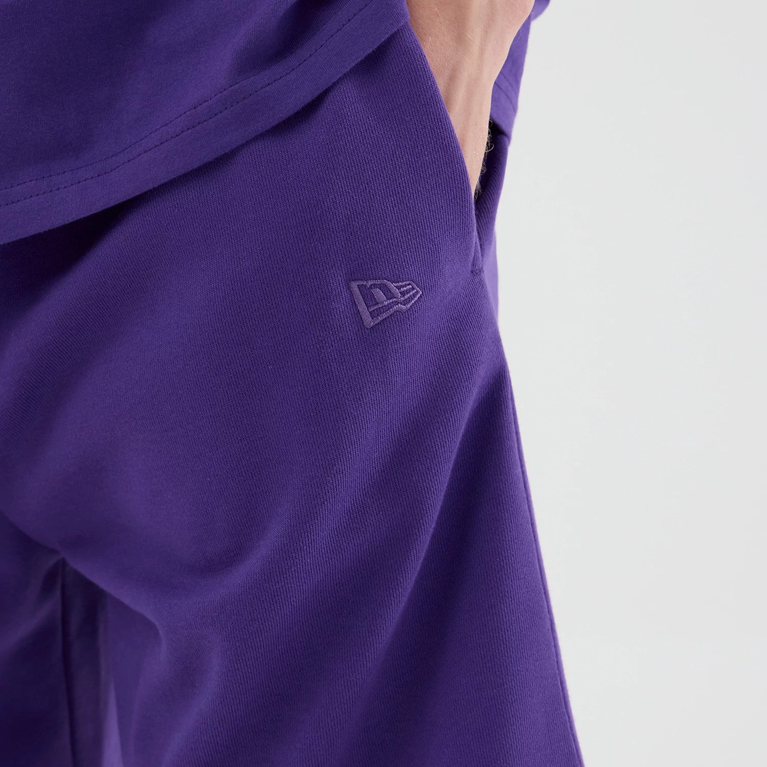 The model is wearing these NBA League Essential LA Lakers Oversized Shorts in purple. 5