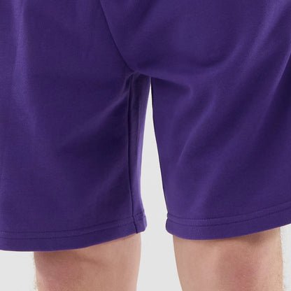The model is wearing these NBA League Essential LA Lakers Oversized Shorts in purple. 6