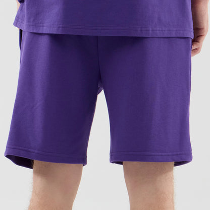 The model is wearing these NBA League Essential LA Lakers Oversized Shorts in purple. 7