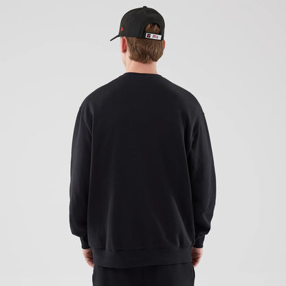 The model is wearing this NBA League Essential Chicago Bulls Oversized Crew Neck Sweater in black. 2