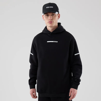The model is wearing this New Era Tech Oversized Pullover Hoodie in black. 1