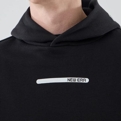 The model is wearing this New Era Tech Oversized Pullover Hoodie in black. 4
