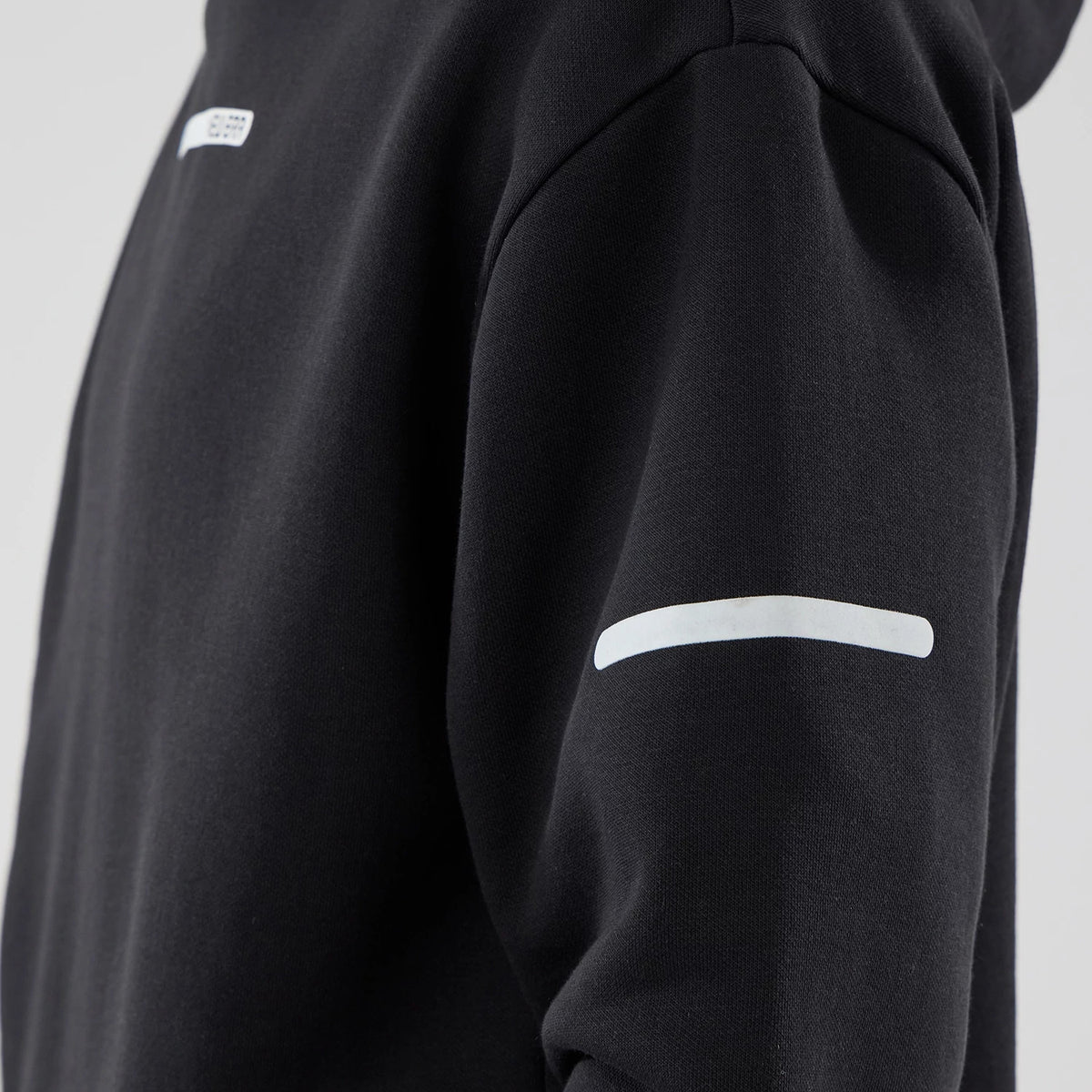 The model is wearing this New Era Tech Oversized Pullover Hoodie in black. 6