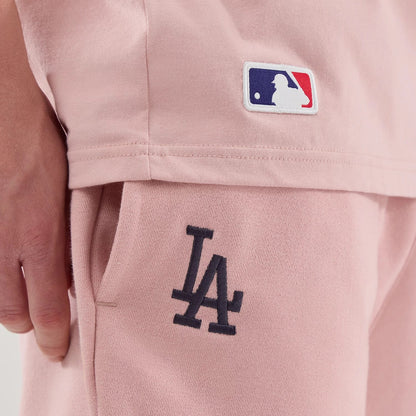 The model is wearing these MLB Midi League Essential LA Dodgers Oversized Shorts in pastel pink. 4