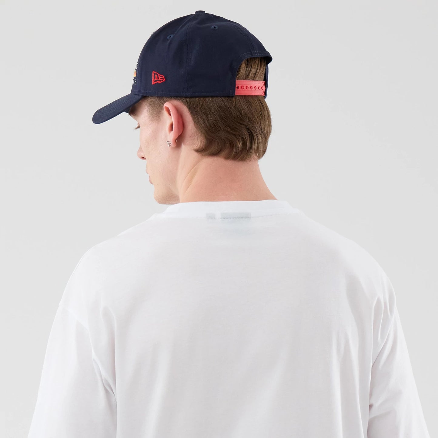 The model is wearing this Red Bull Racing Graphic Oversized T-Shirt in white. 7