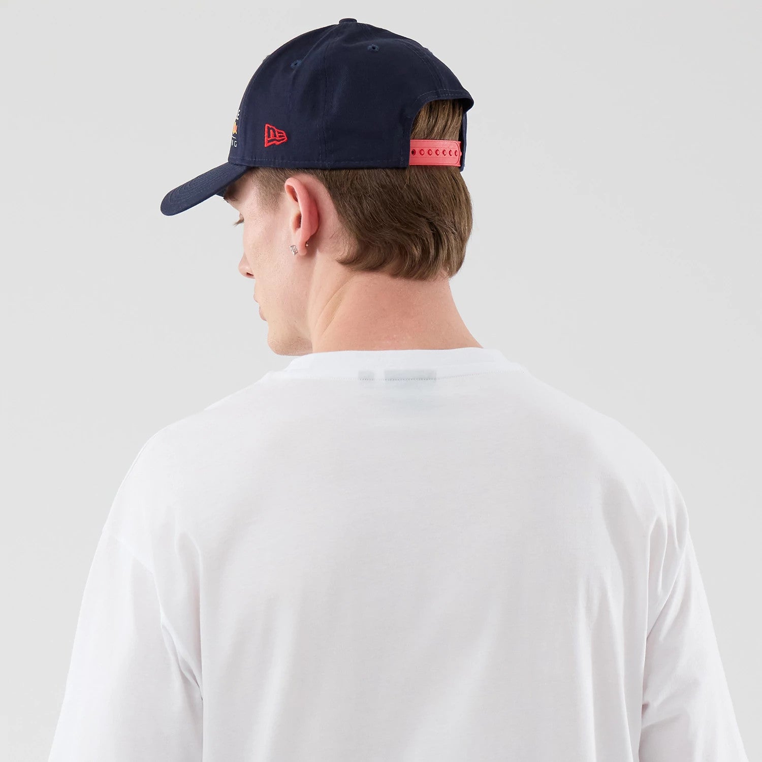 The model is wearing this Red Bull Racing Graphic Oversized T-Shirt in white. 7