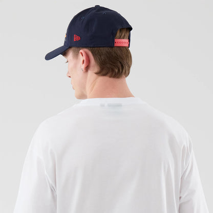 The model is wearing this Red Bull Racing Graphic Oversized T-Shirt in white. 7