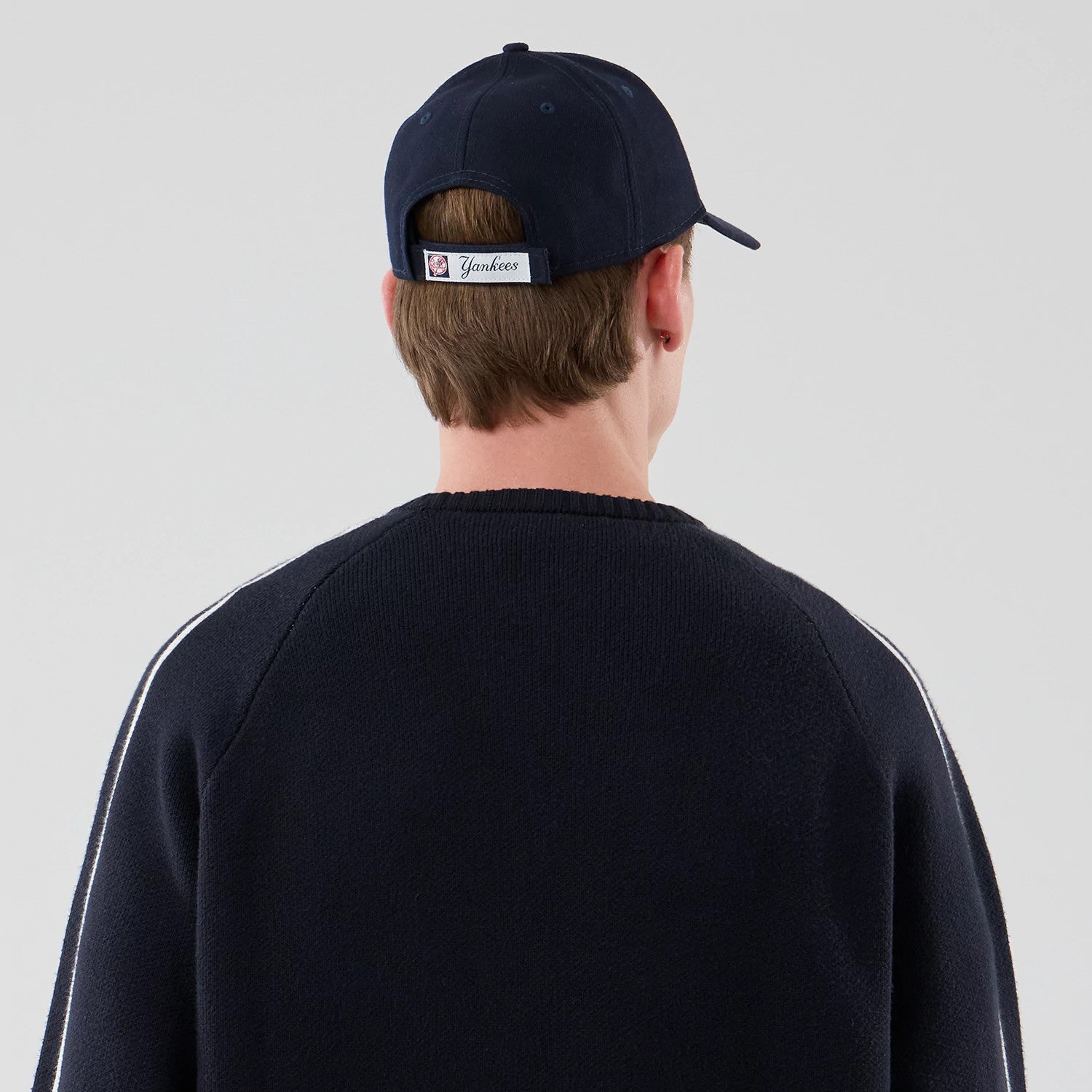 The model is wearing this MLB Knit New York Yankees Knitted Sweater in navy. 7