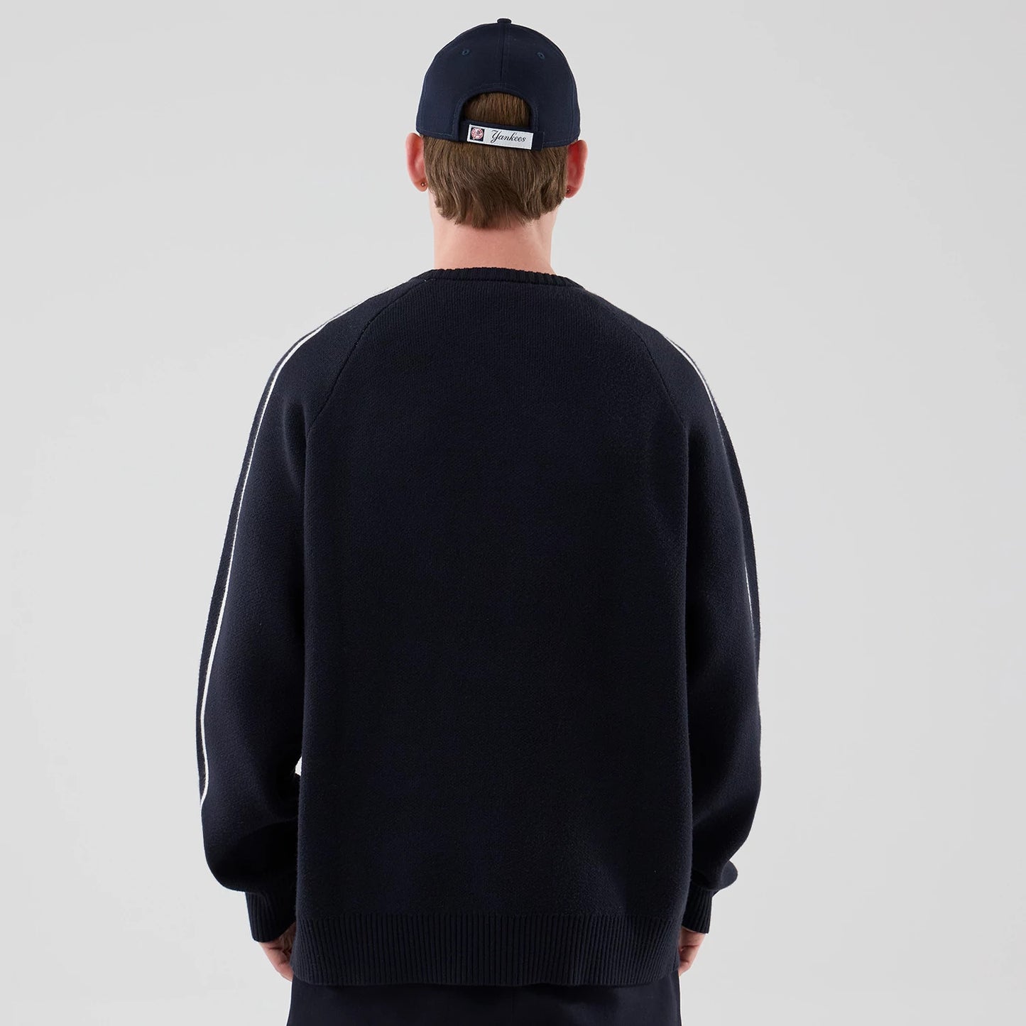 The model is wearing this MLB Knit New York Yankees Knitted Sweater in navy. 2