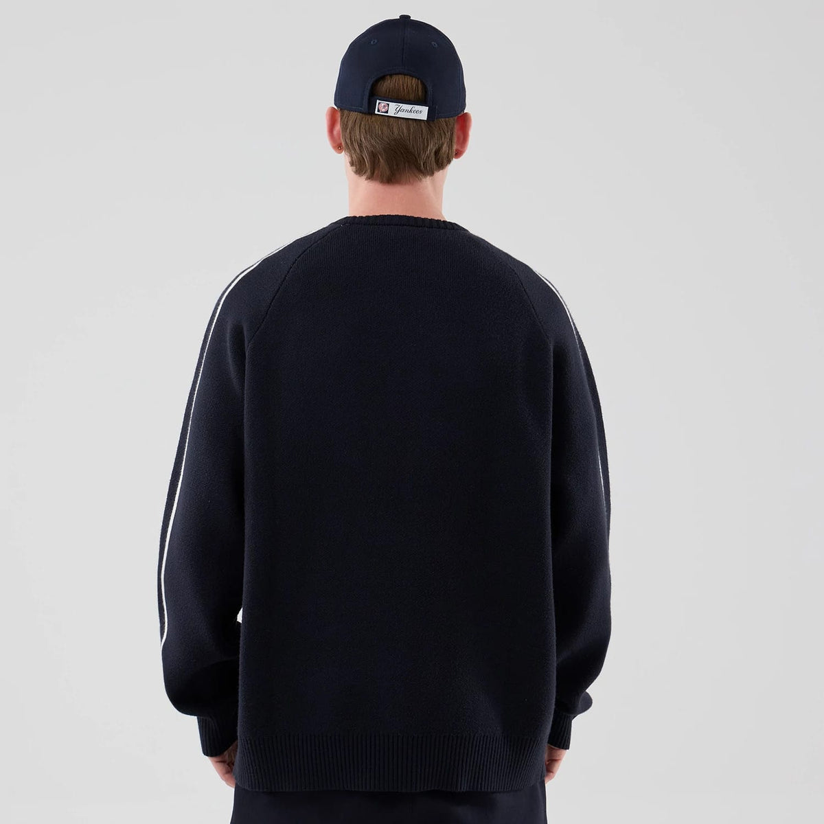 The model is wearing this MLB Knit New York Yankees Knitted Sweater in navy. 2