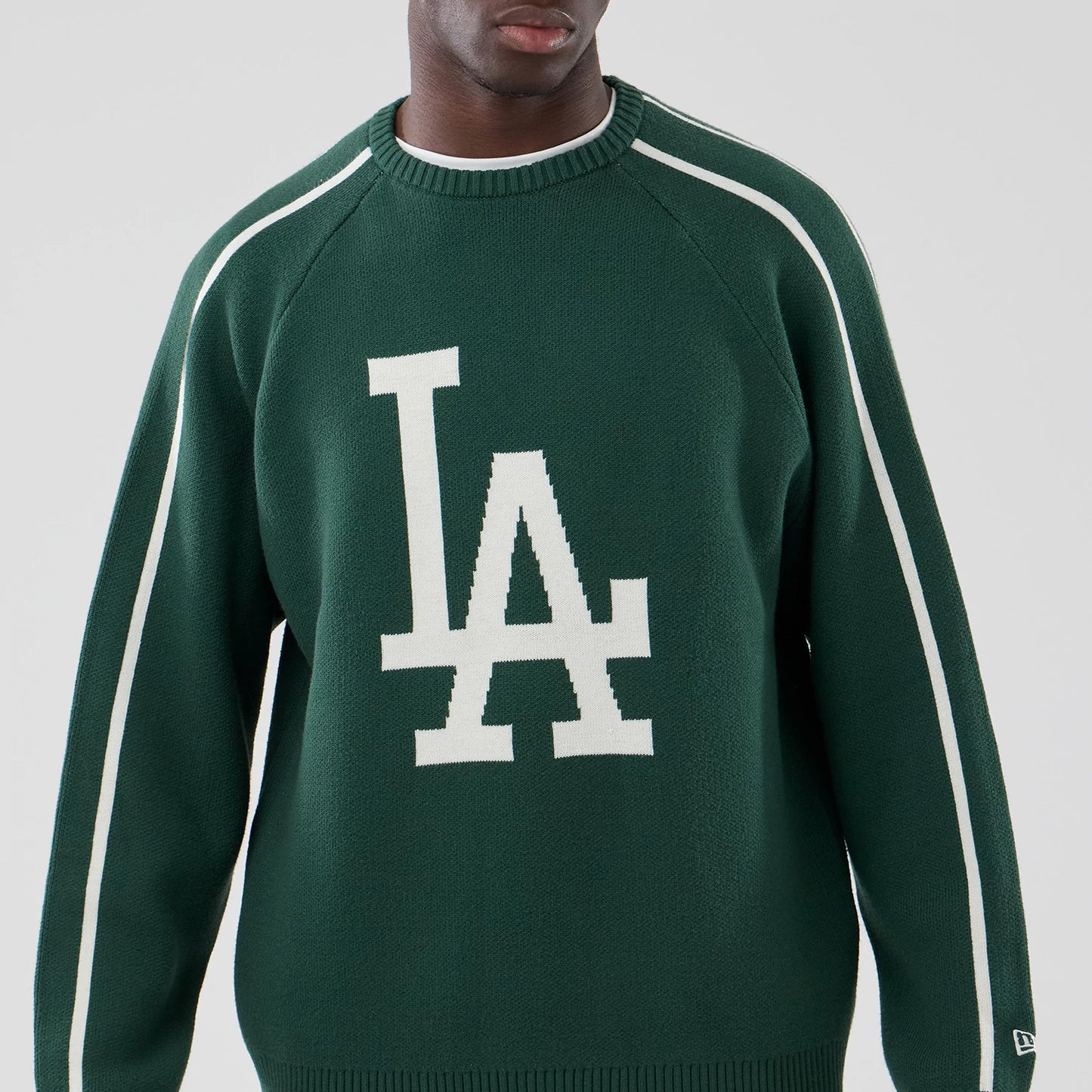 The model is wearing this MLB Knit LA Dodgers Knitted Sweater in dark green. 3