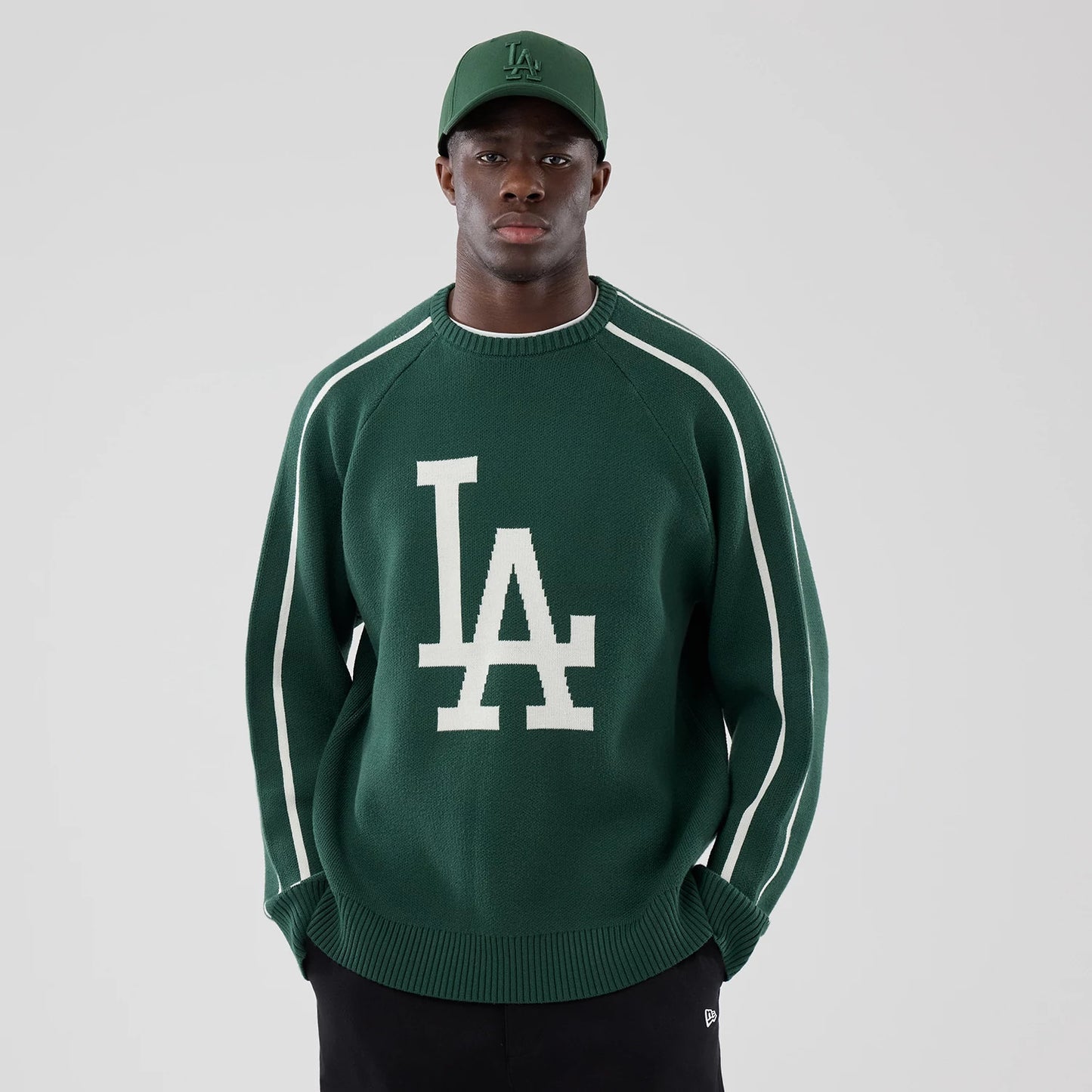 The model is wearing this MLB Knit LA Dodgers Knitted Sweater in dark green. 1