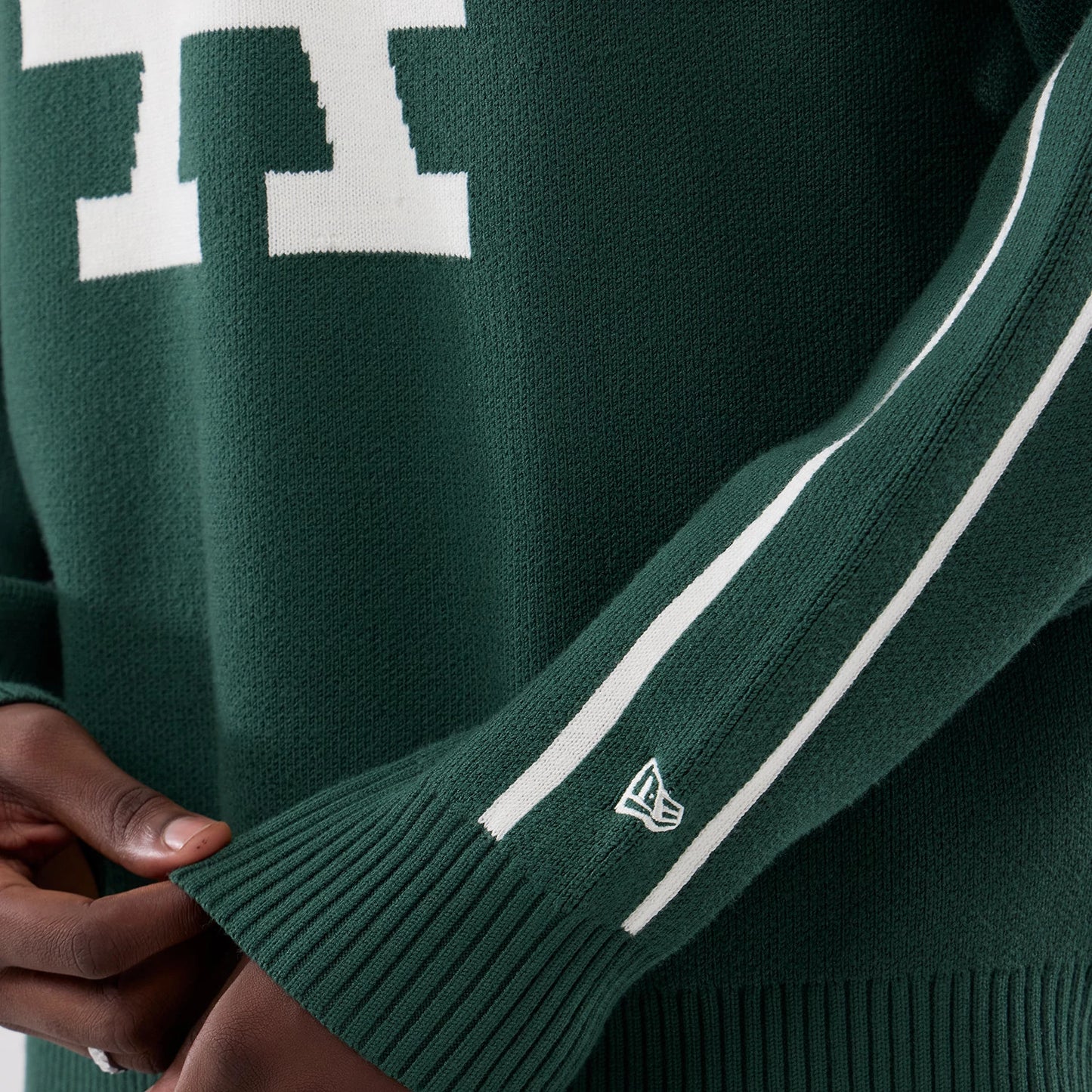 The model is wearing this MLB Knit LA Dodgers Knitted Sweater in dark green. 5