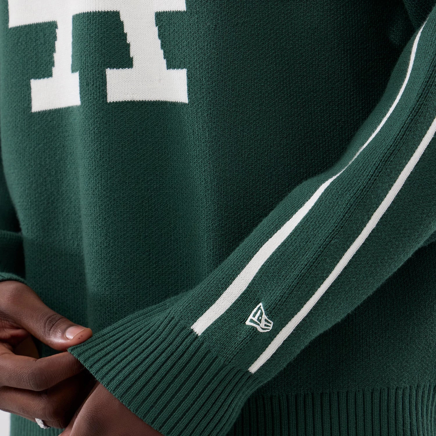 The model is wearing this MLB Knit LA Dodgers Knitted Sweater in dark green. 5