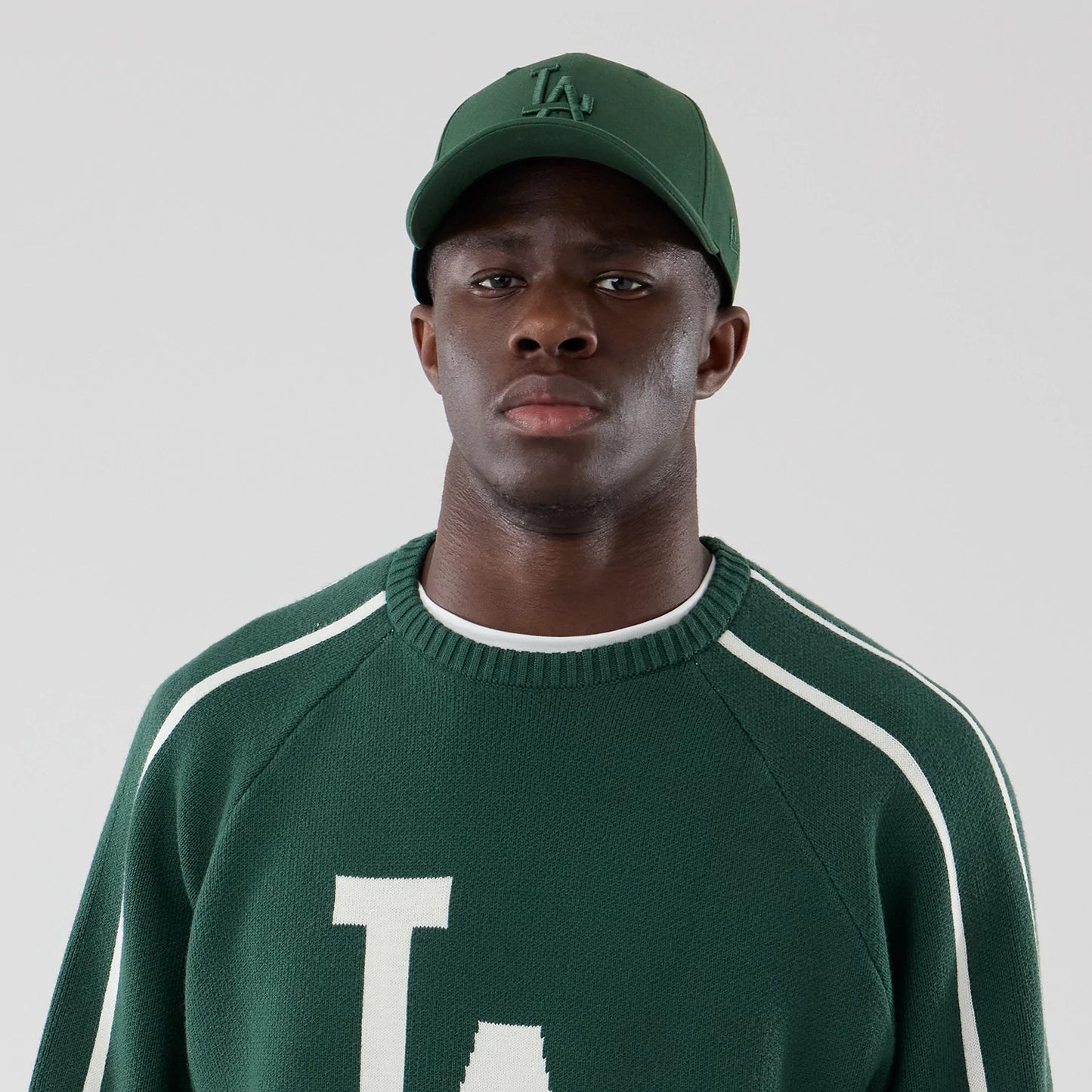 The model is wearing this MLB Knit LA Dodgers Knitted Sweater in dark green. 6