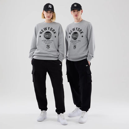 The model is wearing this MLB Graphic New York Yankees Oversized Crew Neck Sweater in grey. 1