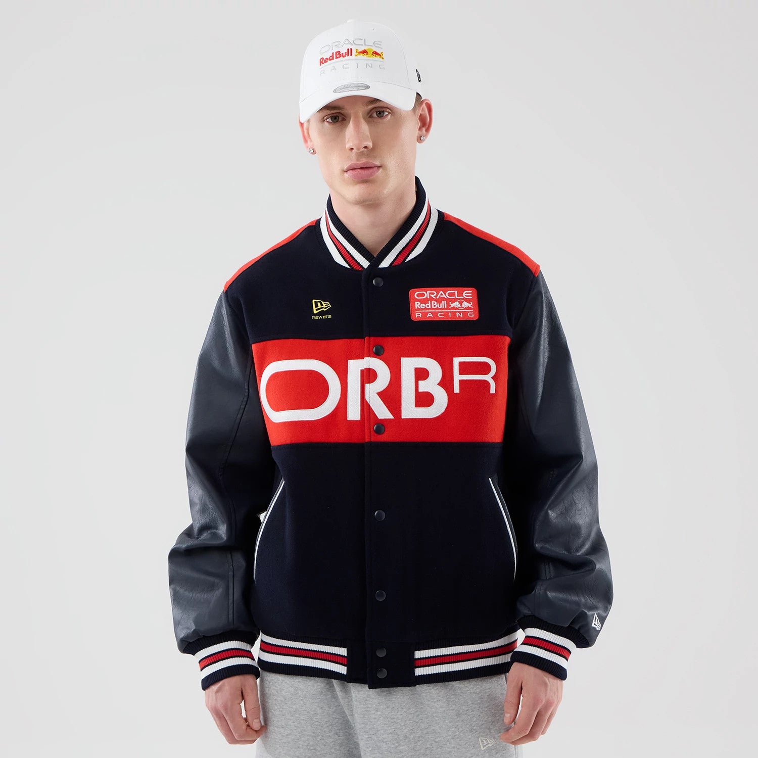 The model is wearing this Red Bull Racing wordmark Varsity Jacket in dark blue. 1