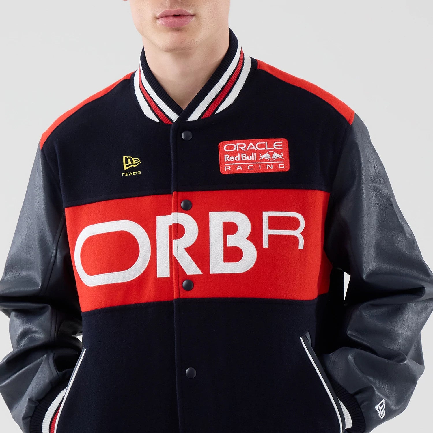 The model is wearing this Red Bull Racing wordmark Varsity Jacket in dark blue. 3