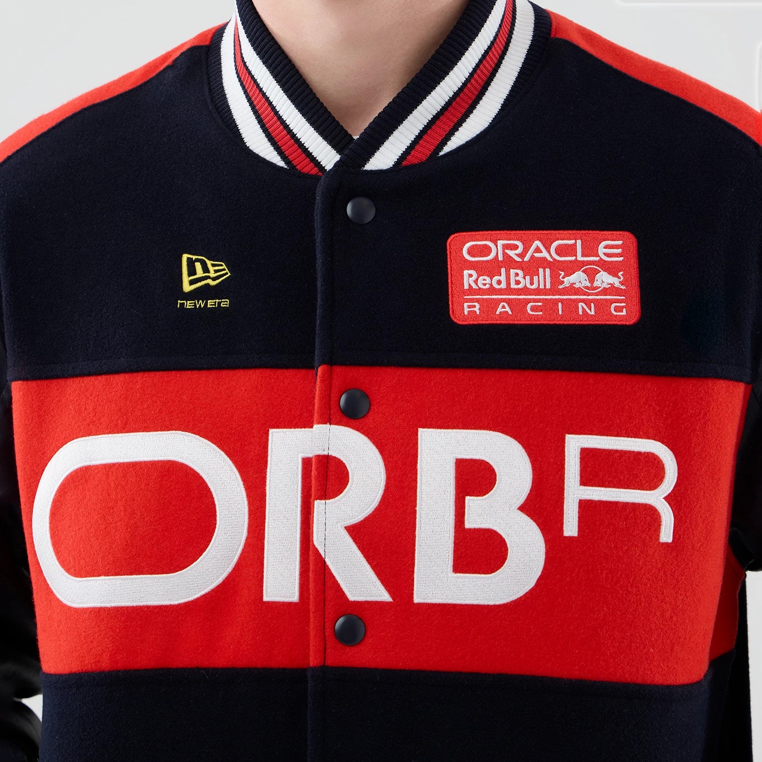 The model is wearing this Red Bull Racing wordmark Varsity Jacket in dark blue. 4