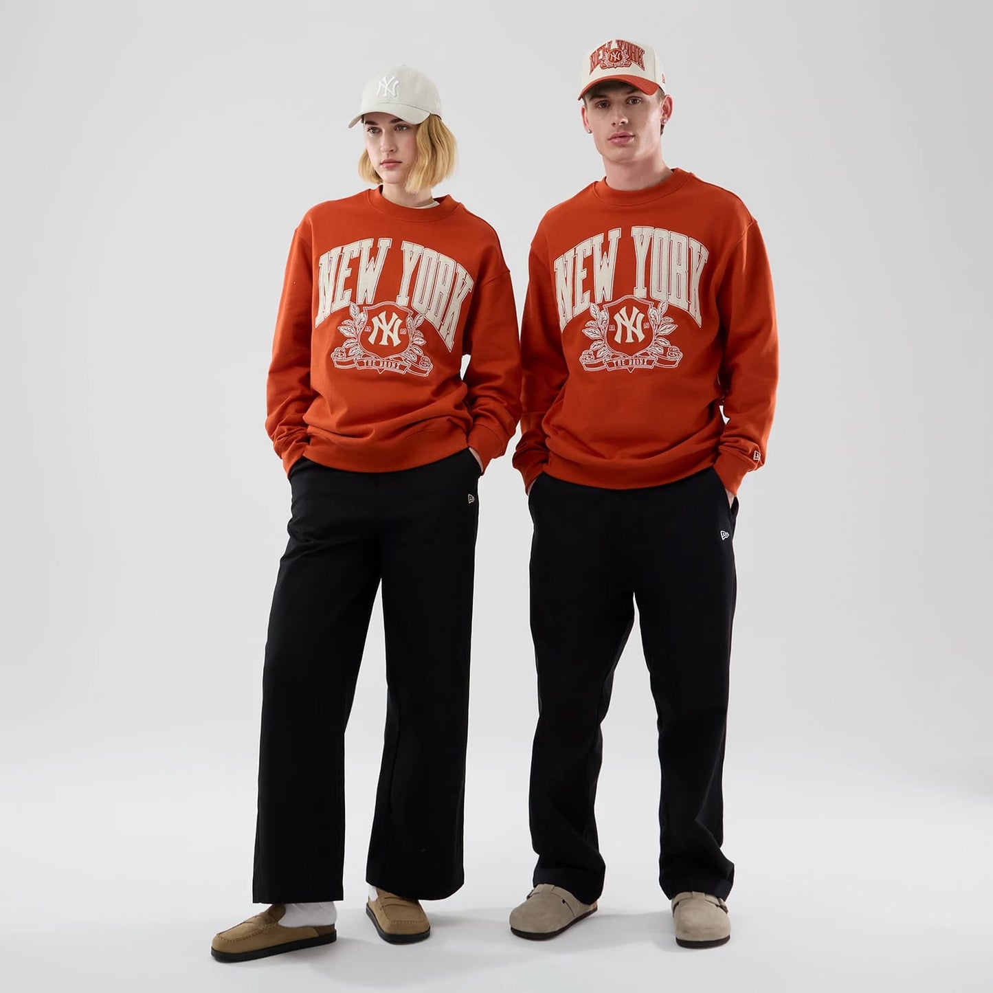 The model is wearing this MLB Arch Graphic New York Yankees Oversized Crew Neck Sweater in Orange. 1