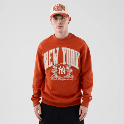 The model is wearing this MLB Arch Graphic New York Yankees Oversized Crew Neck Sweater in Orange. 3