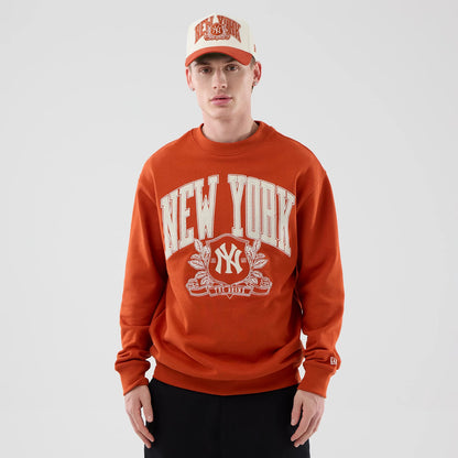 The model is wearing this MLB Arch Graphic New York Yankees Oversized Crew Neck Sweater in Orange. 3