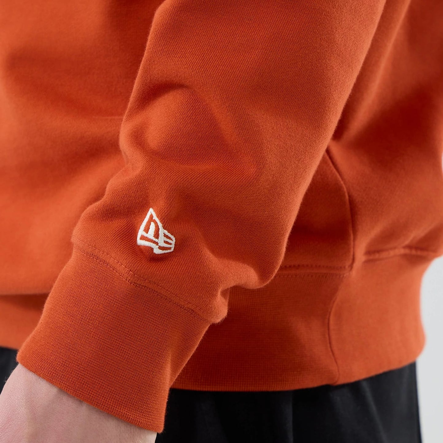 The model is wearing this MLB Arch Graphic New York Yankees Oversized Crew Neck Sweater in Orange. 7