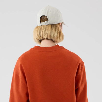 The model is wearing this MLB Arch Graphic New York Yankees Oversized Crew Neck Sweater in Orange. 8